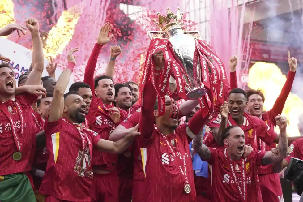 Liverpool players celebrate with the winner’s trophy