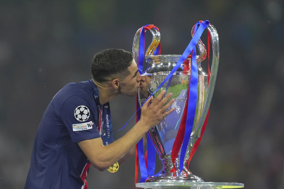 PSG Achraf Hakimi kisses the trophy after winning the Champions League final